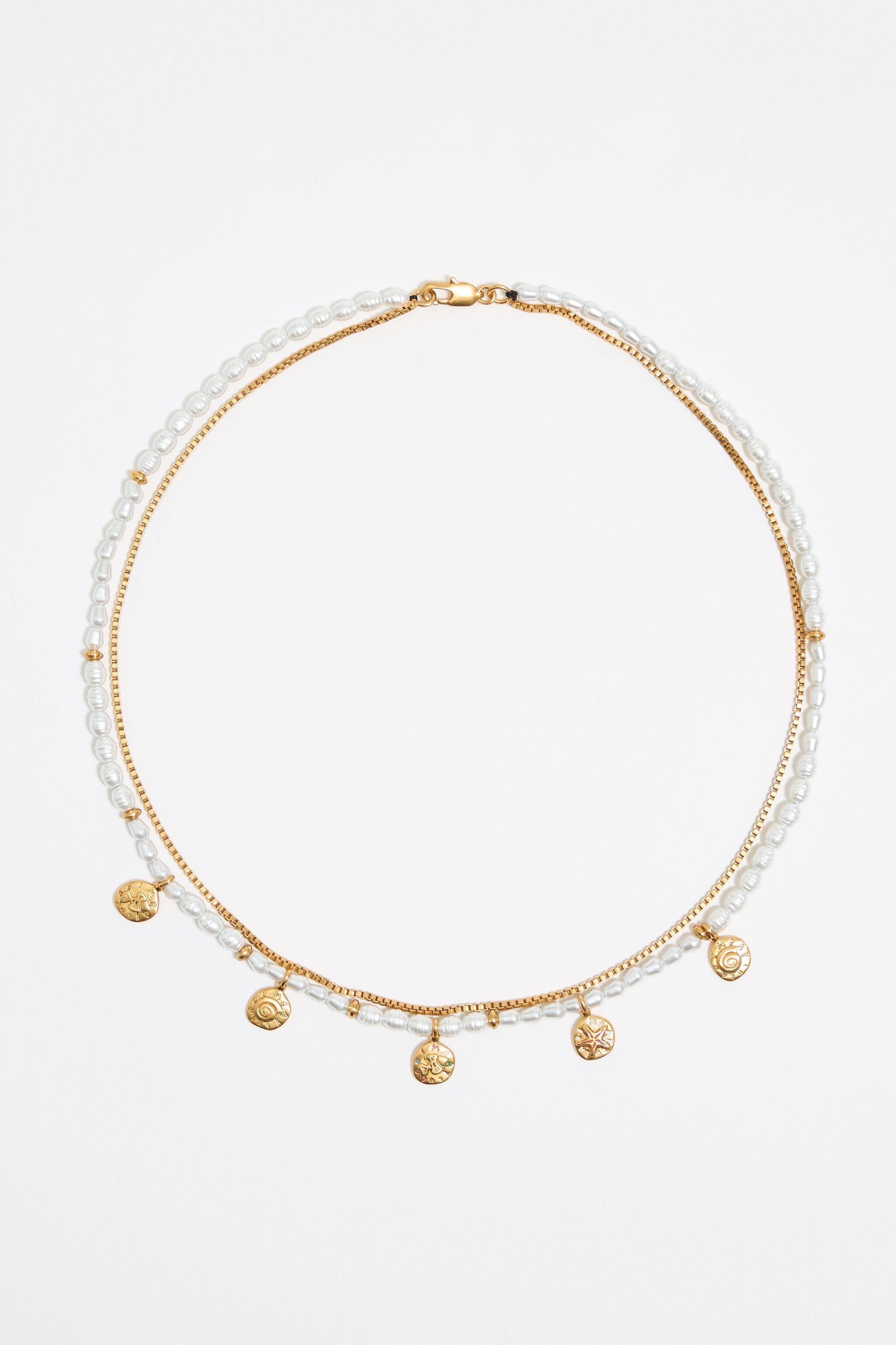 Gold coin logo and pearl necklace